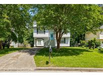 Charming two-story home with well-maintained lawn and mature trees at 5250 Forest Downs Ln, Atlanta, GA 30349