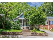 Charming home with a well-maintained front yard and inviting entrance, surrounded by mature trees at 364 Brooks Ne Ave, Atlanta, GA 30307