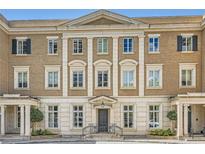 Elegant multi-story townhome with detailed architectural features and manicured landscaping at 2440 Peachtree Nw Rd # 9, Atlanta, GA 30305