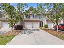 Charming townhome featuring a two-car garage, brick accents, and well-maintained landscaping in a desirable community at 2280 Baker Station Dr, Acworth, GA 30101