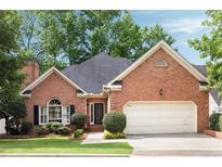 Charming brick home featuring a two-car garage, manicured landscaping, and a classic design at 1887 Chamdun Pl, Brookhaven, GA 30341