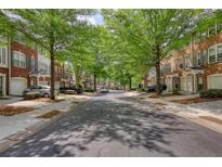 Charming townhomes line a tree-shaded street in a well-maintained community, offering a welcoming neighborhood feel at 2160 Dillard Xing, Tucker, GA 30084