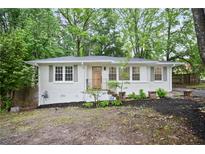 Charming, freshly painted brick home with a new door, updated landscaping, and lots of curb appeal at 3480 Mount Olive Rd, Atlanta, GA 30344