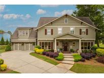 Charming two-story home with well-maintained landscaping and a three car garage at 525 E Main St, Buford, GA 30518