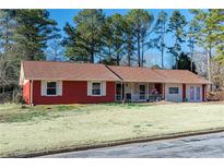 Charming single-story home with a red brick exterior and a well-manicured front yard at 1830 Brandy Se Ln, Conyers, GA 30013