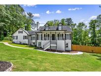 Charming two-story home with a inviting front porch and a well-manicured lawn at 1384 Sunrise Way, Lawrenceville, GA 30046