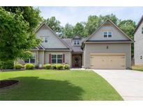 Charming two-story home featuring a well-manicured lawn and an attached two-car garage at 4690 Hopewell Manor Dr, Cumming, GA 30028
