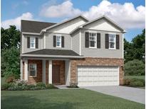 Charming two-story home features a brick facade and well-maintained landscaping at 7785 Sudbury Cir, Covington, GA 30014