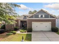 Charming brick home with a two-car garage, manicured lawn, and beautiful landscaping at 120 Laurel Rdg, Canton, GA 30114
