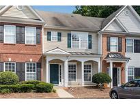 Inviting townhome with manicured front yard and charming architectural details, ready for new owners at 621 Kenridge Way # 0, Suwanee, GA 30024