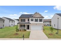 Charming two-story home with a two car garage and well-maintained front yard at 25 Amberjack Trl, Covington, GA 30016