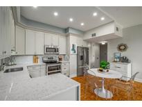 Well-lit kitchen with stainless steel appliances, white cabinets, and a quartz countertop at 130 26Th Nw St # 415, Atlanta, GA 30309