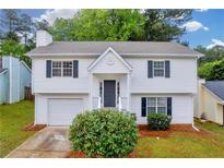 Charming two-story home with white siding, black shutters, and well-manicured lawn at 1645 Cobbs Creek Ln, Decatur, GA 30032