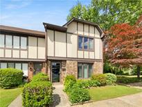 Inviting front exterior showcasing a landscaped yard, walkway and a well-maintained townhome at 1805 Ashborough Se Cir # H, Marietta, GA 30067