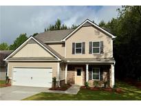 Charming two-story home with neutral siding, stone accents, and an attached two-car garage at 48 Beaver Pt, Villa Rica, GA 30180