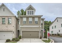 Two-story home featuring a two-car garage, neat landscaping, and light brown siding at 351 Gaines St, Marietta, GA 30060
