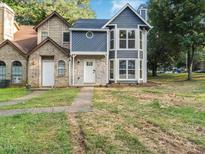 Charming townhouse with stone and blue wood facade, complemented by bright white trim and ample windows at 845 Heritage Dr, Stone Mountain, GA 30088