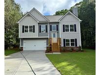 Charming two-story home with a two-car garage, landscaped yard, and classic curb appeal at 48 Deer Pl, Villa Rica, GA 30180