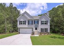 Charming two-story home featuring a two-car garage and inviting front porch at 48 Deer Pl, Villa Rica, GA 30180