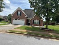 Charming brick home with a well-maintained front yard and a two-car garage at 1266 Laurelwood Ct, Lawrenceville, GA 30045