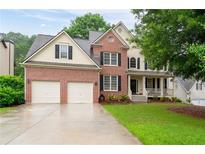 Charming two-story brick home with a well-manicured lawn and attached two-car garage at 138 Knightwood Pt, Acworth, GA 30101