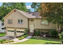 Charming two-story home featuring a two-car garage and manicured front lawn at 2958 Cordite Loop, Snellville, GA 30039