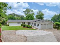 Charming one-story home with a well-manicured lawn and a two-car garage at 3125 Cardinal Lake Cir, Duluth, GA 30096