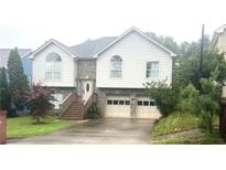 Charming two-story home boasts a brick-accented facade, symmetrical design, and a well-maintained front yard at 585 Station View Run, Lawrenceville, GA 30043