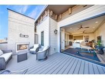 Inviting outdoor patio featuring a fireplace and views into a cozy living area at 661 Auburn Ne Ave # 10, Atlanta, GA 30312