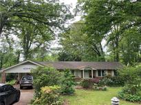 Ranch home exterior with covered parking and mature trees in an established neighborhood at 1481 Pine St, Stone Mountain, GA 30087