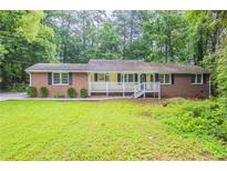 Charming single-story home with a brick facade, complemented by a well-maintained front yard at 4201 Hicks Rd, Austell, GA 30106