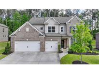 Beautiful two-story brick home features a two-car garage and manicured lawn at 13055 Fox Rd, Alpharetta, GA 30005