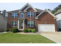 Beautiful two-story brick home with a well-manicured lawn and two car garage at 232 Clubhouse Xing, Acworth, GA 30101