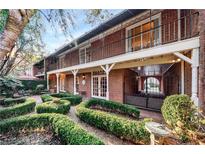 Charming brick home featuring a manicured backyard, an iron gate, and inviting outdoor seating areas at 3456 Paces Nw Pl, Atlanta, GA 30327