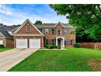 Traditional brick two-story home with a well-manicured lawn and two-car garage at 3153 Daleview Sw Way, Atlanta, GA 30331