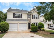 Charming two-story home features a two-car garage and well-maintained landscaping at 411 Sugar Maple Ct, Canton, GA 30114