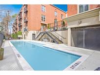 Stunning outdoor community pool with modern design situated near a brick apartment building at 560 Dutch Valley Ne Rd # 2207, Atlanta, GA 30324