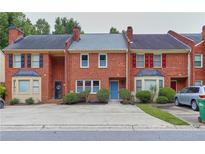 Brick townhome with landscaping, driveway and street view at 3144 Corner Oak Dr, Norcross, GA 30071