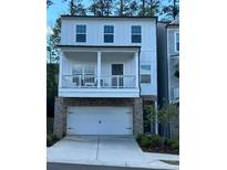 Charming two-story home with a stone-accented garage and cozy front porch at 409 Ruths Blvd, Woodstock, GA 30188