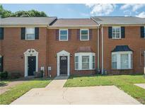 Traditional brick townhouse with a well-maintained front yard and private driveway at 1507 Paces Ferry North Se, Smyrna, GA 30080