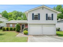 Charming two-story home with gray siding, blue shutters, and a well-manicured lawn at 734 Kilkenny Cir, Lithonia, GA 30058