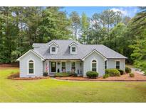 Charming single-story home with a well-manicured lawn, lush landscaping, and inviting curb appeal at 836 Palmetto Tyrone Rd, Sharpsburg, GA 30277