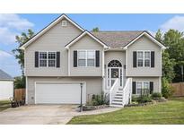Charming two-story home featuring neutral siding, black shutters and inviting front entrance with landscaped yard at 251 Hunt Club Cir, Temple, GA 30179