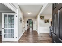 Inviting hallway featuring wood-look floors and neutral paint, leading to various rooms and areas of the home at 321 Woodbrook Crst, Canton, GA 30114