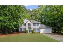 Charming two-story home with a well-manicured lawn, blue shutters and a two car garage at 3927 Collier Nw Trce, Kennesaw, GA 30144