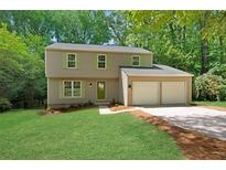 Charming two-story home with a well-maintained lawn, complemented by fresh landscaping and a convenient two-car garage at 4368 Heritage Glen Ct, Marietta, GA 30068