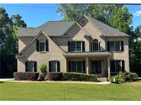 Charming two-story brick home with manicured lawn, black shutters, and inviting front porch at 2785 Old Sewell Rd, Marietta, GA 30068