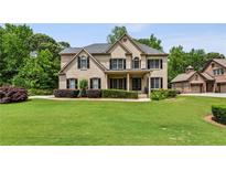 Beautiful brick home with a well-manicured lawn and mature trees providing privacy at 2785 Old Sewell Rd, Marietta, GA 30068