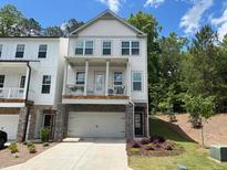 Charming two-story home featuring a covered porch and an attached two-car garage at 507 Bishop Ln, Woodstock, GA 30188