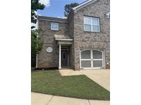 Charming two-story brick home featuring a well-manicured lawn and attached garage at 7055 Blairs View Dr # 1, Austell, GA 30168